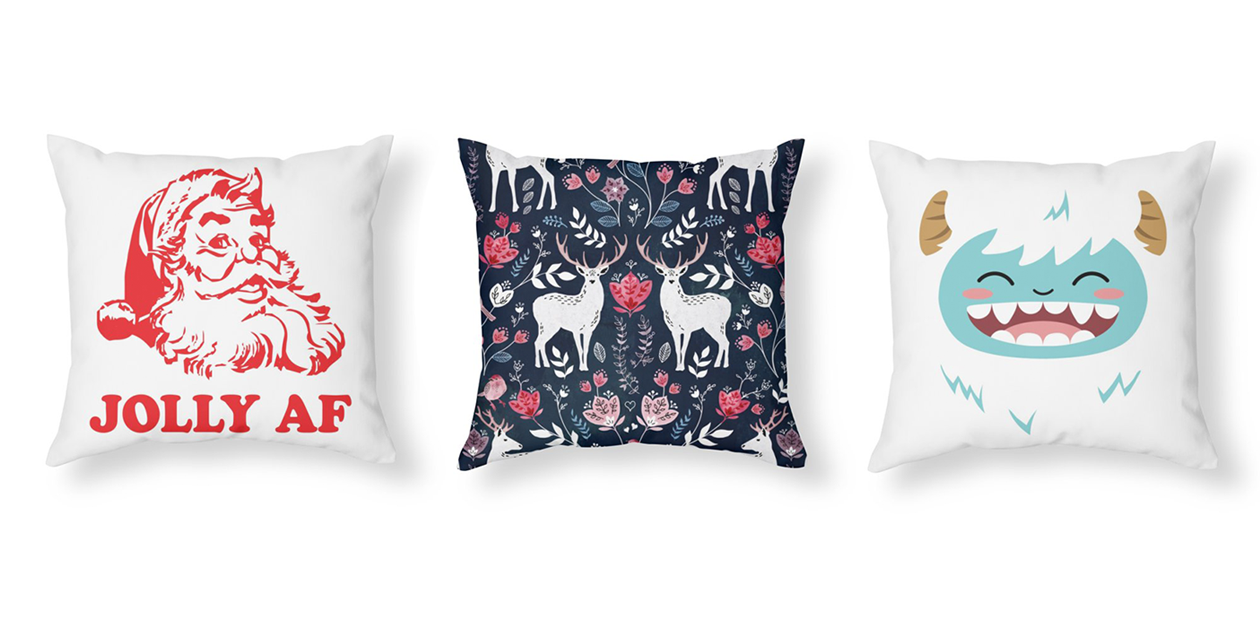 “Jolly AF” Throw Pillow by 3bagsfulltees, “Scandinavian Deer” Throw Pillow by AdenaJ, and “Happy Yeti” Throw Pillow by JCLovely