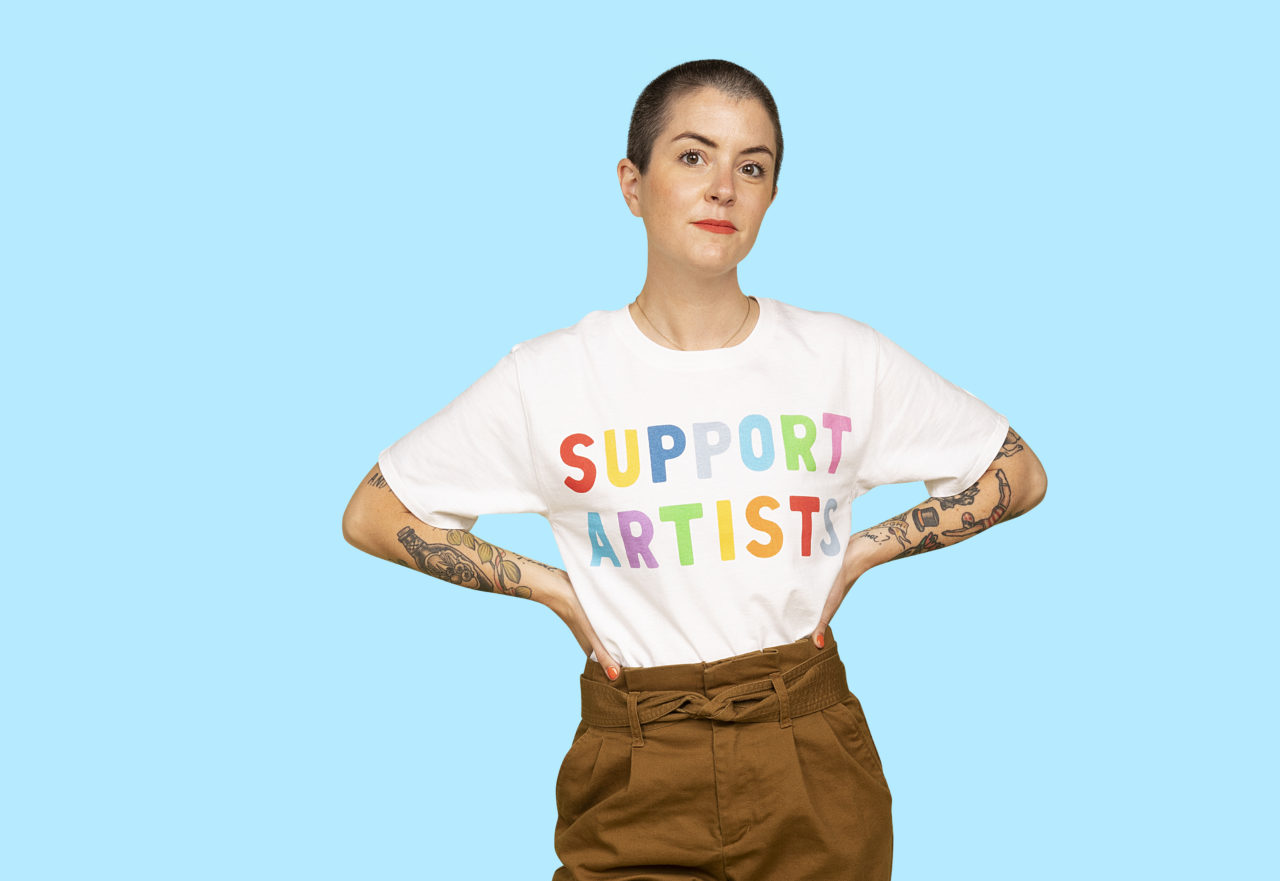 Whitney LaMora wearing EmelineTate’s “Support Artists” Champion® T-Shirt